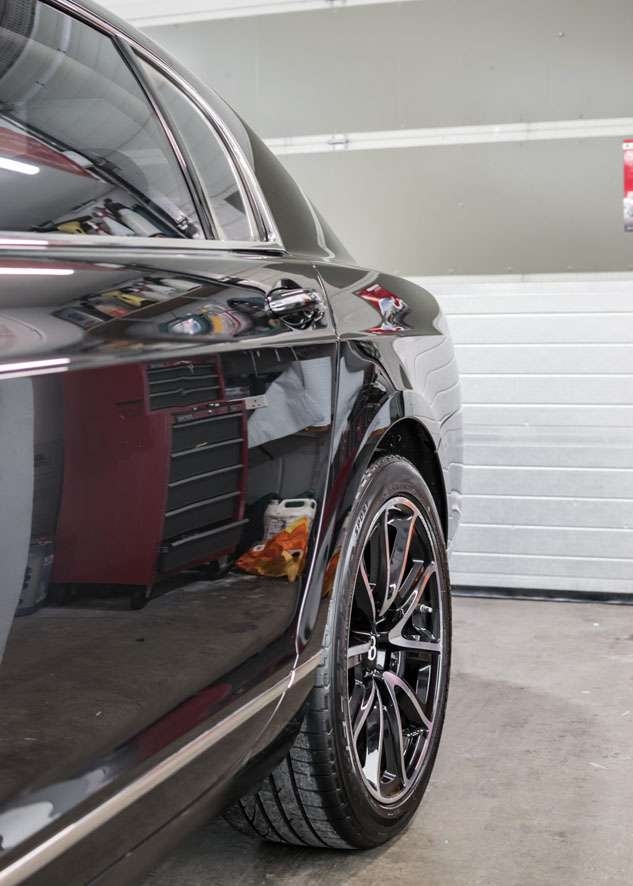 Rear side shot of Bentley Flying Spur car with paintwork shine/gloss restored by polishing, paint correction and Paintwork Enhancement